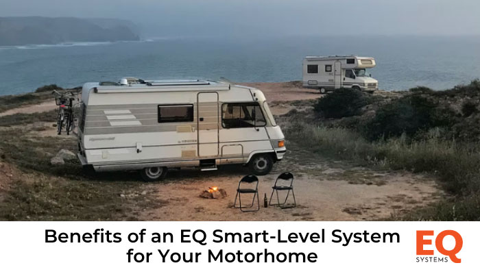 2 motorhomes parked near the ocean.